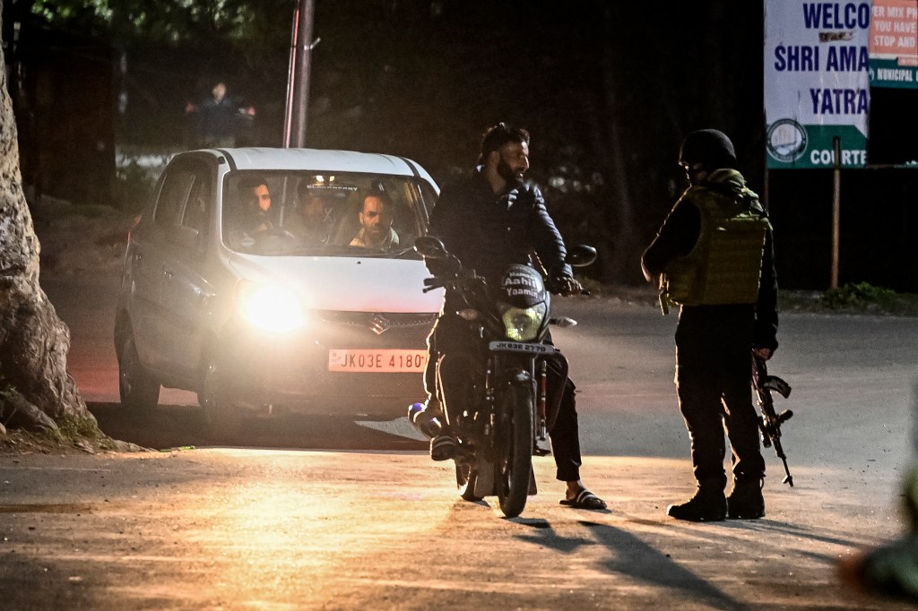 An Indian Army personnel stops vehicles for inspection near Pahalgam, south of Srinagar, on April 22, 2025, following an attack.