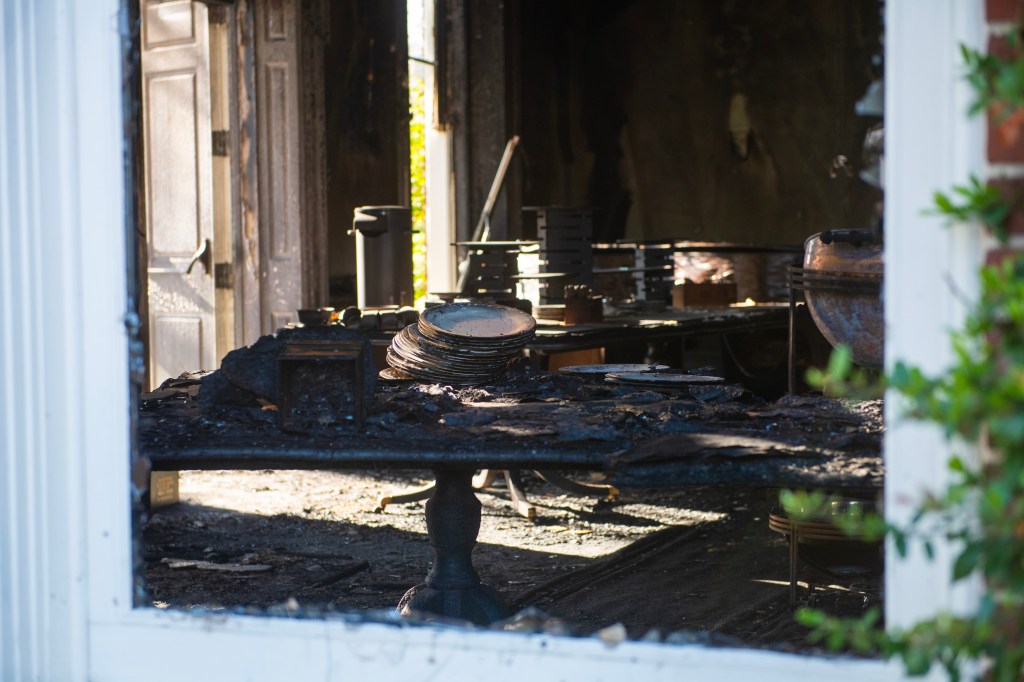 Extensive fire damage to Pennsylvania Governor's Mansion and Governor Josh Shapiro's residence seen during a press conference, featuring a burnt table in a room