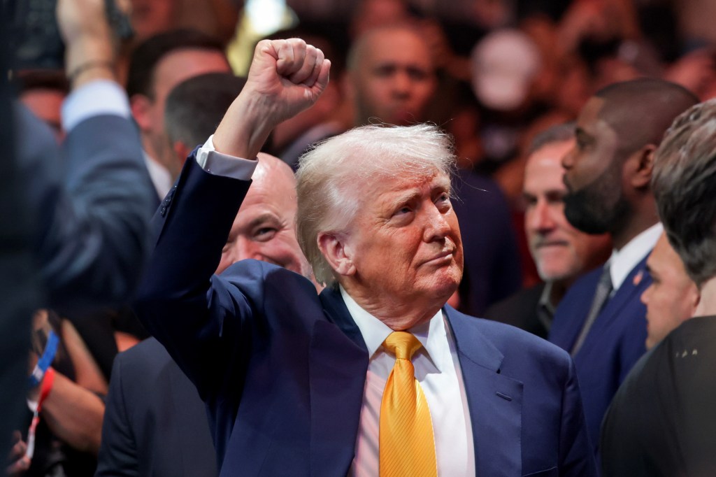 U.S. President Donald Trump raising his fist in gesture to cheering crowds at the Ultimate Fighting Championship in Miami, Florida