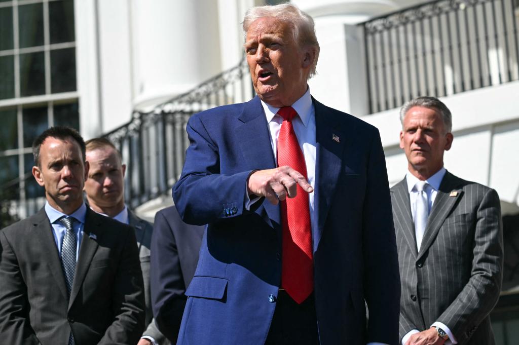 President Donald Trump speaks during a photo opportunity with autoracing officials and champions on the South Portico of the White House on April 9, 2025