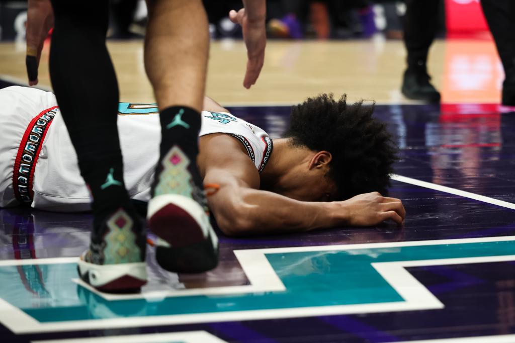 Jaylen Wells #0 of the Memphis Grizzlies lays on the court after an injury during the first half of a basketball game against the Charlotte Hornets at Spectrum Center on April 08, 2025 in Charlotte, North Carolina. 