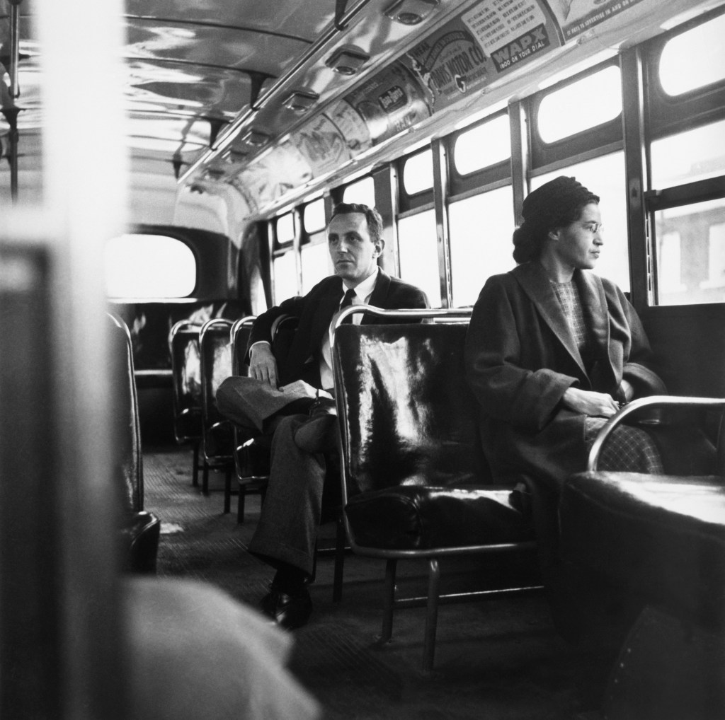 American civil rights activist, Rosa Parks sits in the front of a bus in Montgomery, Alabama, after the Supreme Court ruled segregation illegal on the city bus system on December 21st, 1956