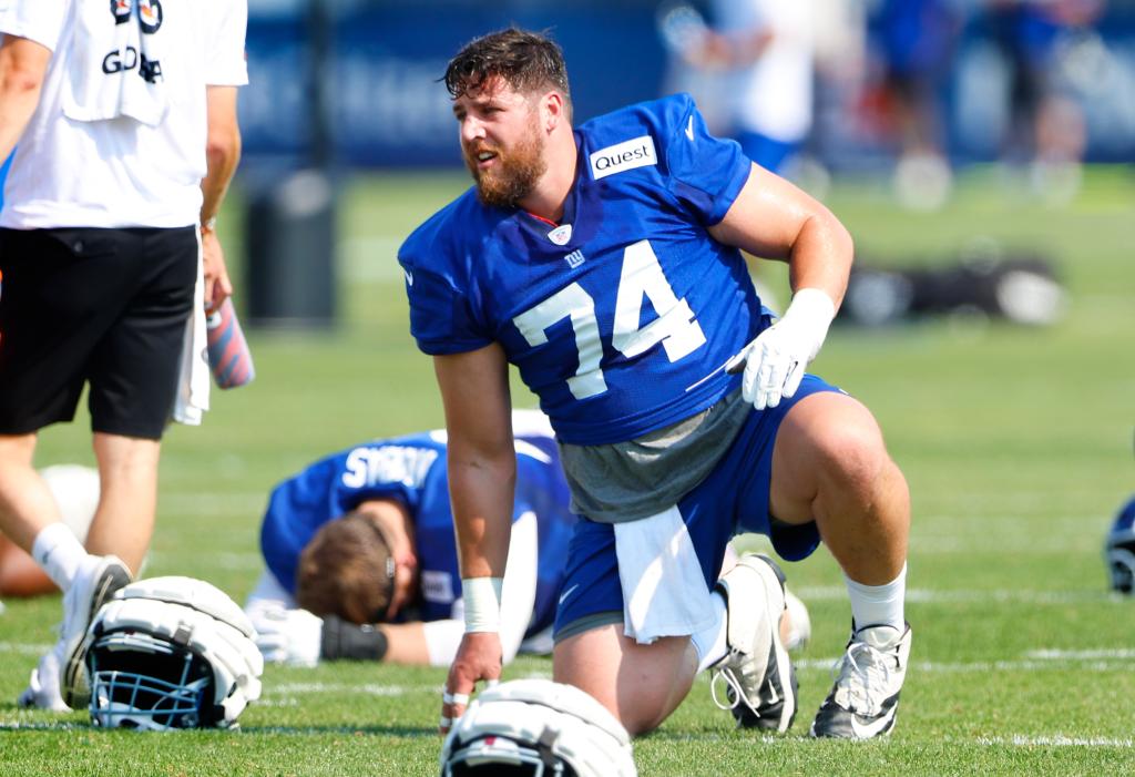 New York Giants guard Greg Van Roten (74) kneeling on the ground during training camp in East Rutherford, N.J., Aug. 1, 2024.
