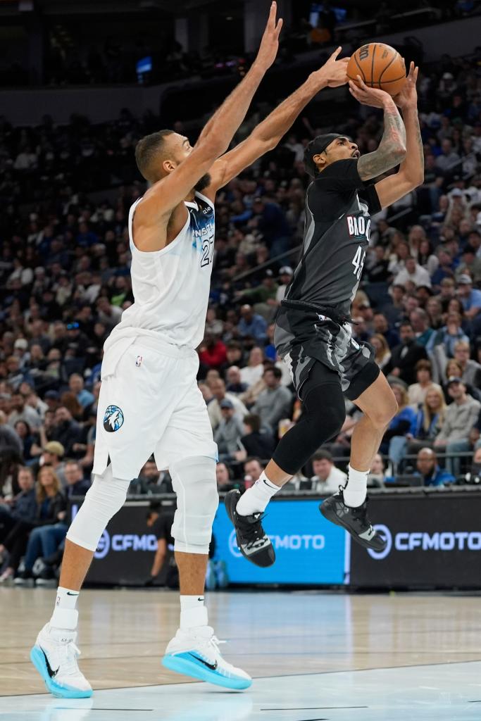 Brooklyn Nets guard Keon Johnson, right, is fouled by Minnesota Timberwolves center Rudy Gobert.