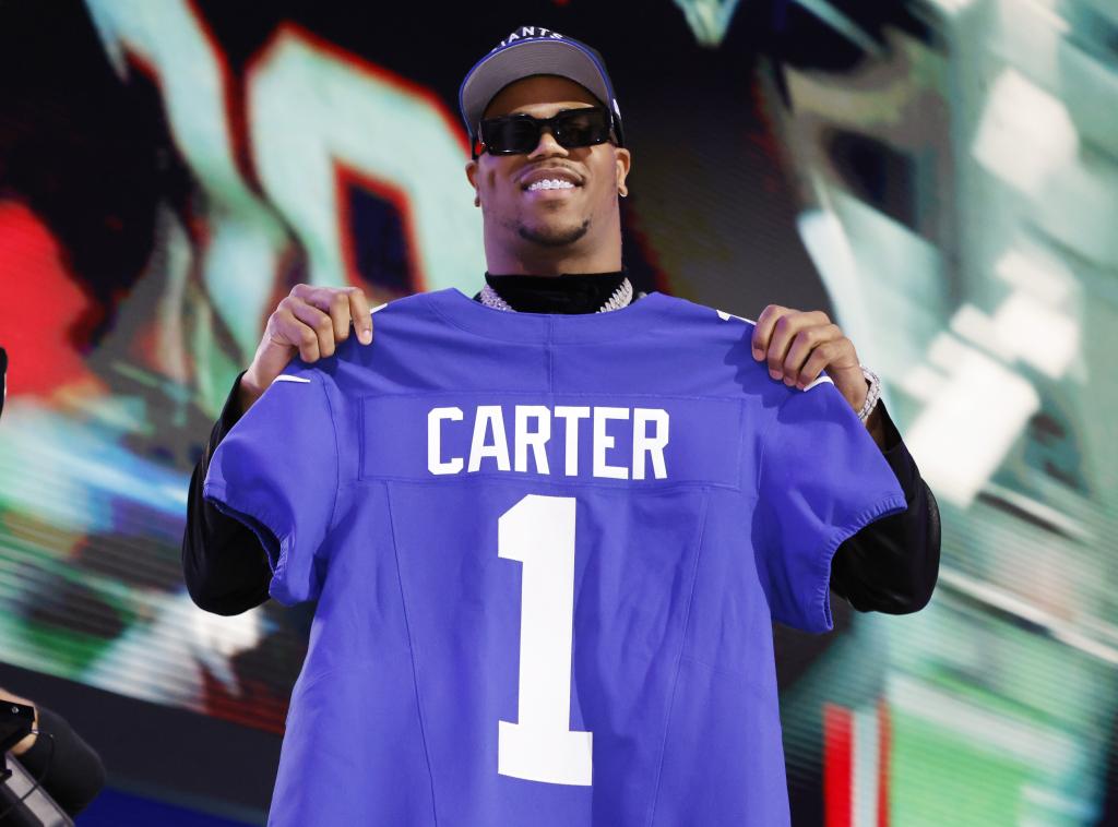 Abdul Carter displays his own Giants jersey after being selected as the NO. 3 pick in the 2025 NFL Draft.