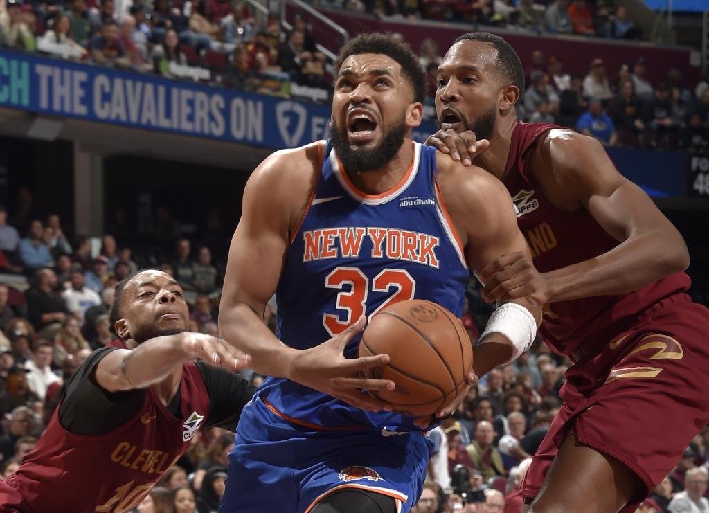 Karl-Anthony Towns drives between two Cleveland defenders during the Knicks' loss to the Cavaliers. 