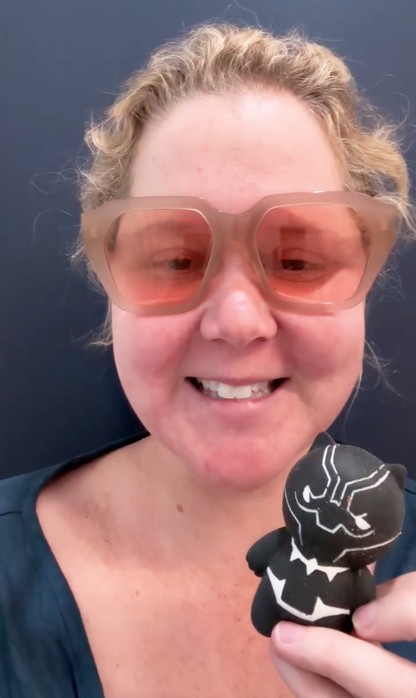 Amy Schumer wearing sunglasses and holding a toy, mocking the all-female Blue Origin launch