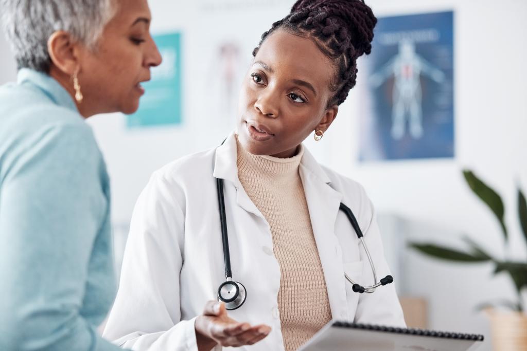 A woman speaks with her doctor. 