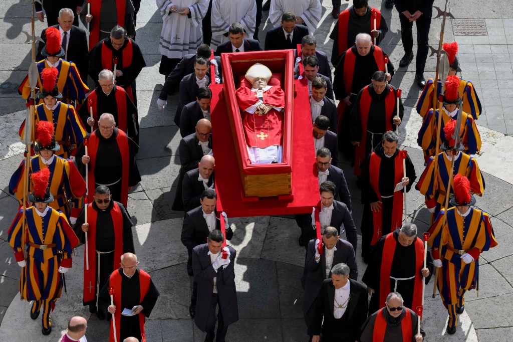 Late Pope Francis' body being carried in an open coffin through St. Peter's Square to St. Peter's Basilica at the Vatican
