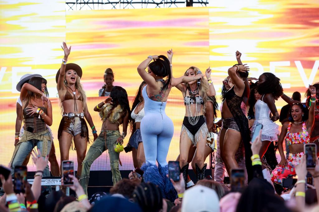 Cardi B performing on stage at Revolve Festival 2025, Cavallo Ranch, California, USA alongside other women including Tamia and Mallory Snyder.