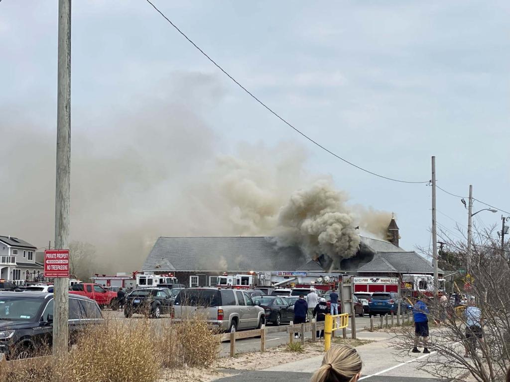smoke billowing from Saint Edmund Church of the Holy Trinity Parish after it caught on fire on April 19, 2025