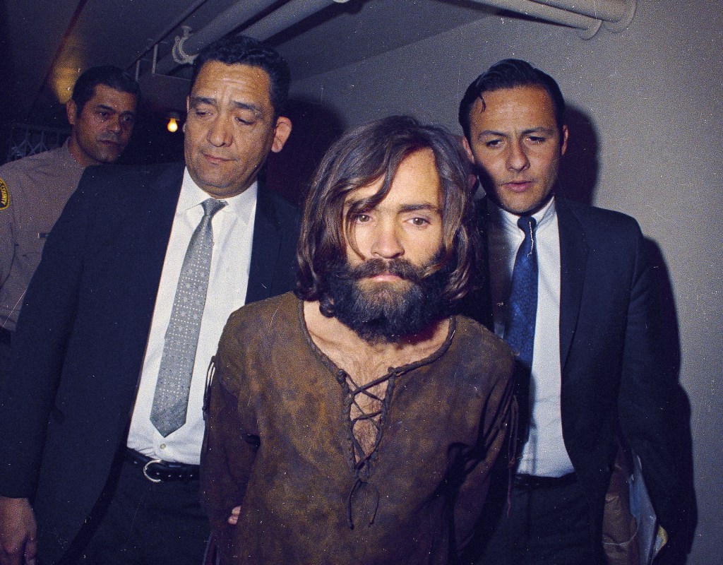 Charles Manson is escorted to his arraignment on conspiracy-murder charges in conneciton with the Sharon Tate murder case, 1969.
