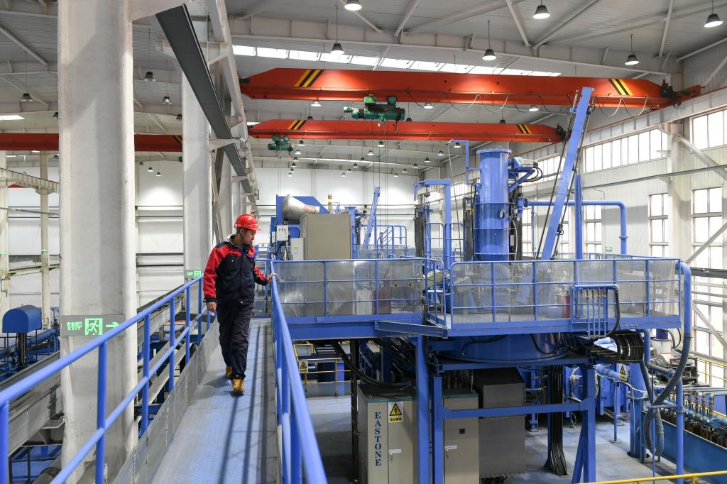 Sun Yujun walking on a walkway at the JL MAG Rare Earth factory in Baotou, Inner Mongolia, China on February 13, 2023