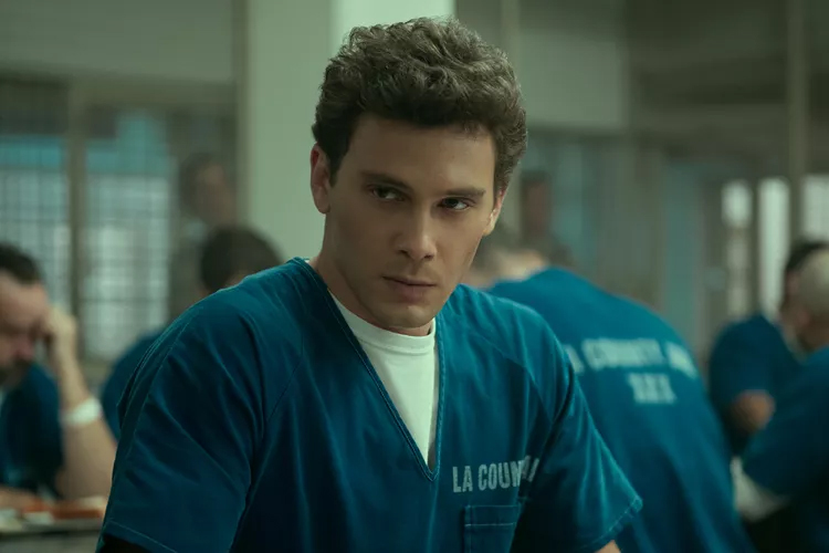 Cooper Koch portraying character Erik Menendez in the Netflix series, wearing a blue shirt
