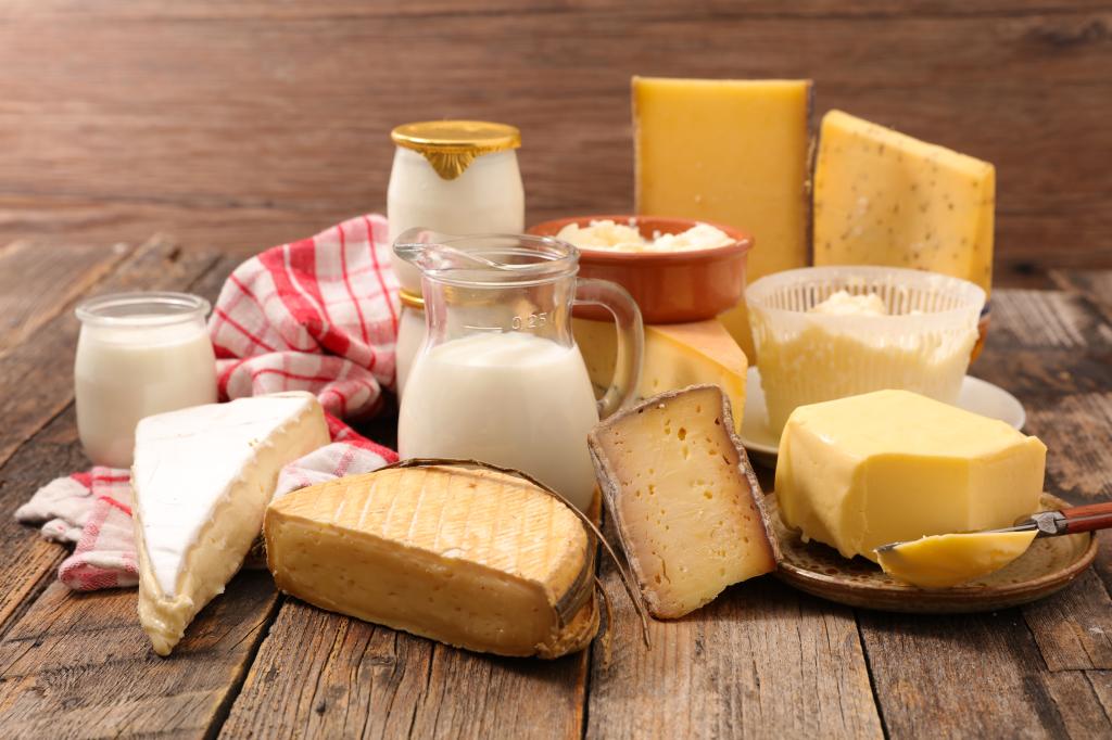 A table with dairy products like milk, cheese and butter. 