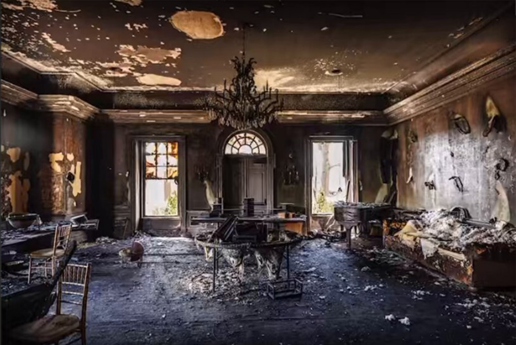 Burned room with a chandelier showing extensive fire damage inside Pennsylvania Governor's residence after arson attack