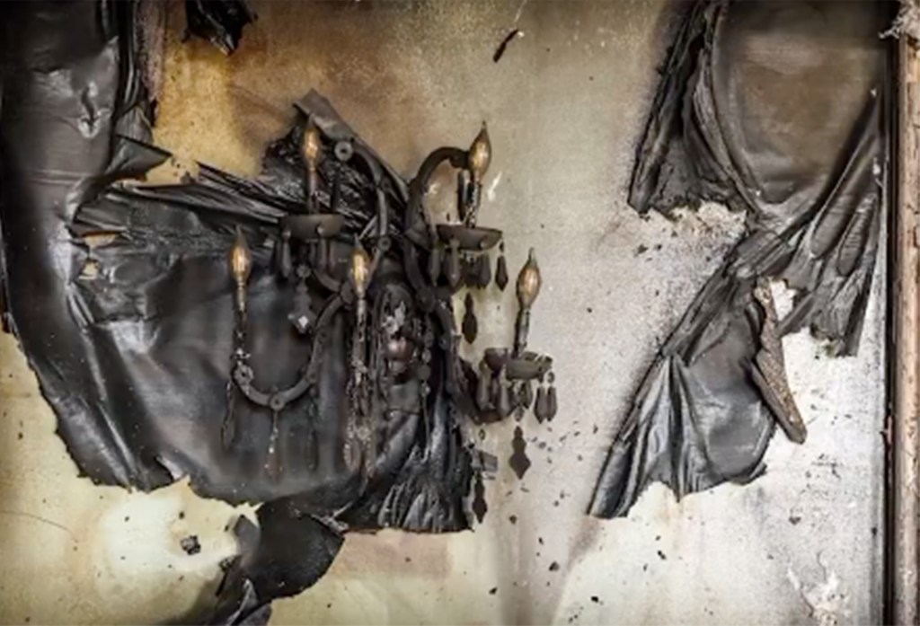 Extensive fire damage inside the Pennsylvania Governor's residence, including a burnt wall with a sconce and a piece of leather