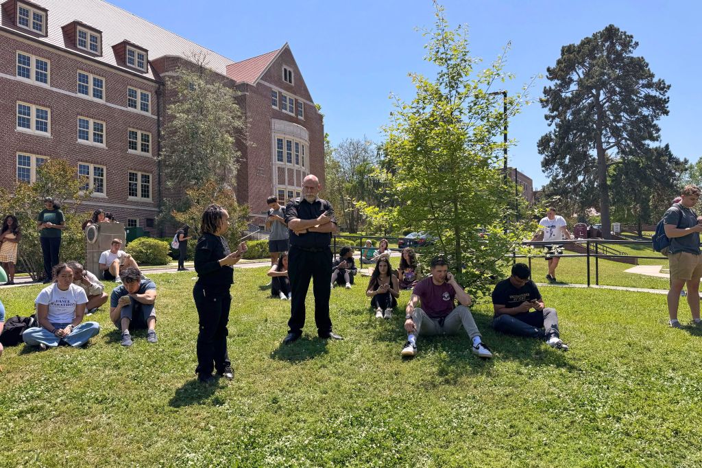 Florida State University students wait for news amid an active shooter incident at the schools campus in Tallahassee, Fla., Thursday, April 17, 2025.