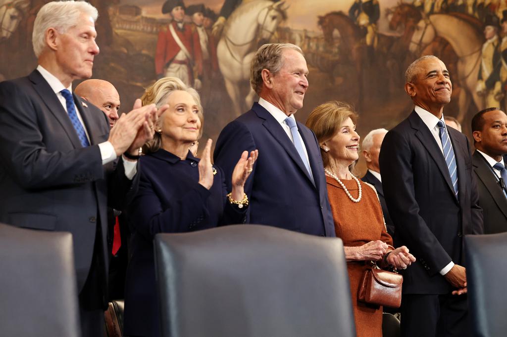 Bill and Hillary Clinton stand with Barack Obama, Laura and George W Bush at Trump's Inauguration in January.