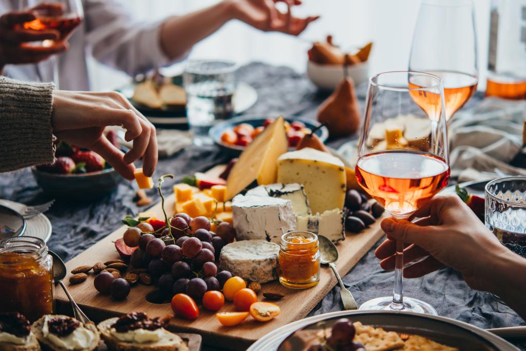 Friends graze on appetizers during a dinner party. 