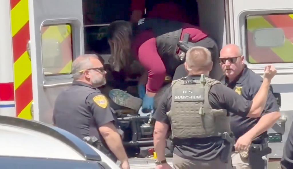Officials shackle Ikner in the back of an ambulance after his arrest on April 17, 2025.