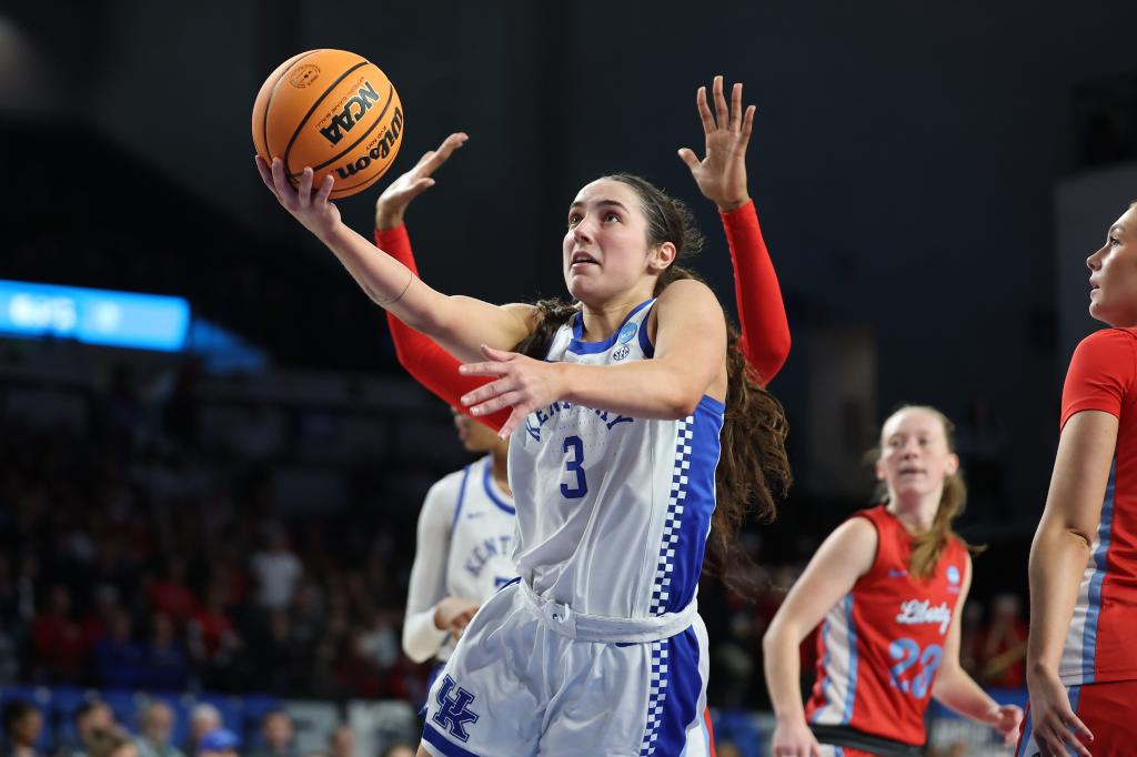 Georgia Amoore of the Kentucky Wildcats driving to the basketball hoop during a match against the Liberty Lady Flames