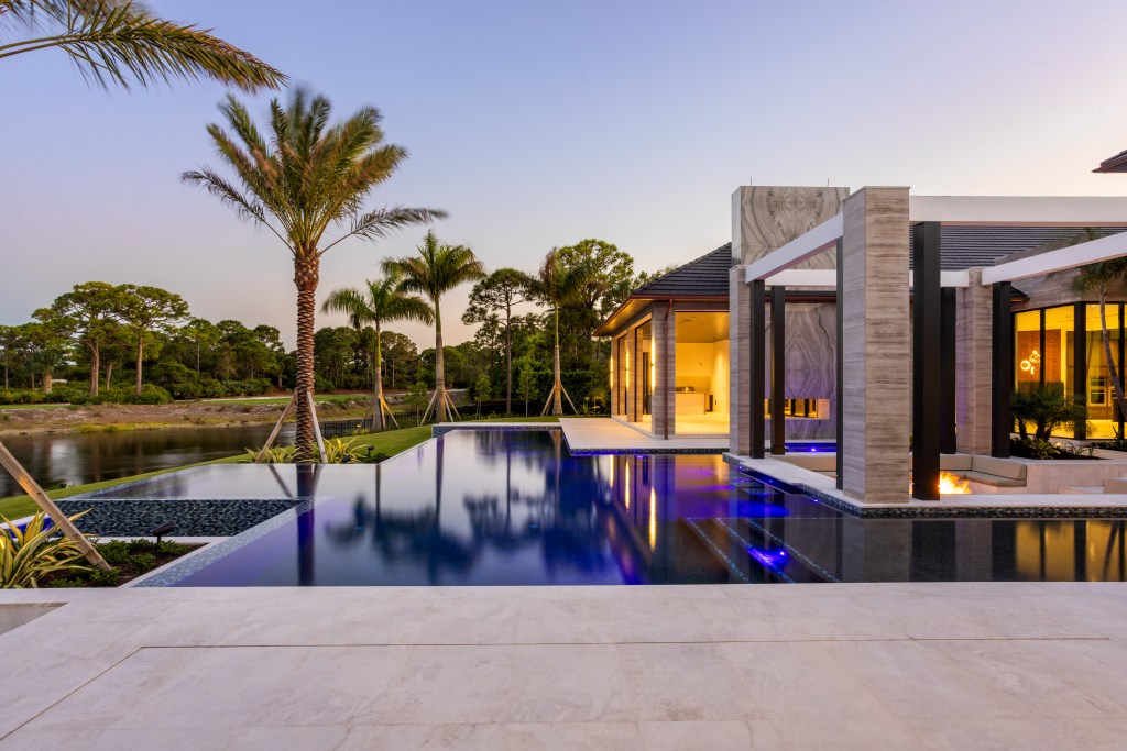 This modern home comes with a midnight blue pool