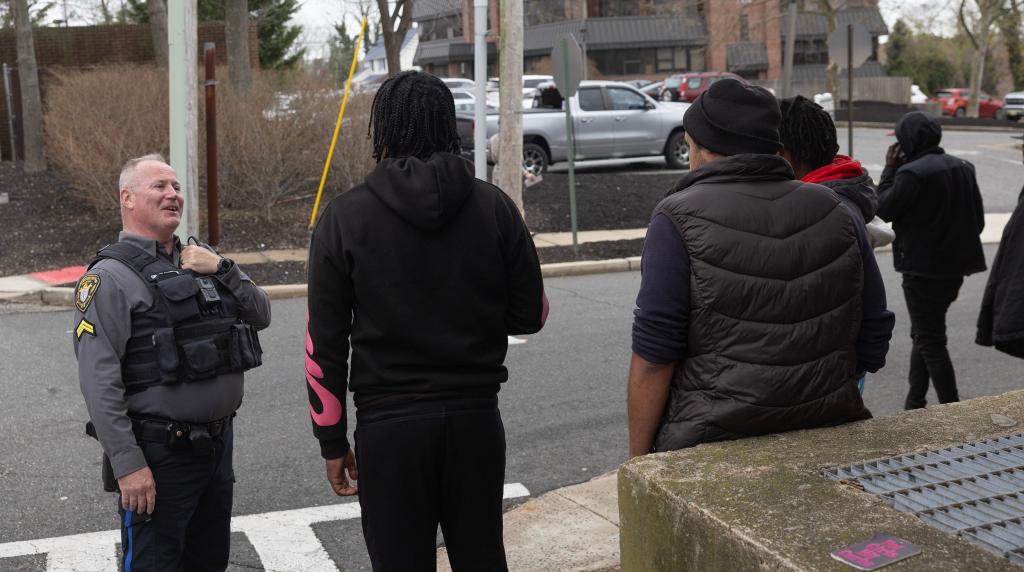 Homeless people hang outside the parking deck for the Ocean County Library 