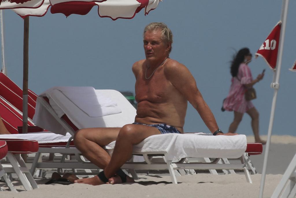 Dolph Lundgren and his wife Emma Krokdal at the beach in Miami, Lundgren in shorts and Emma in a mauve bikini