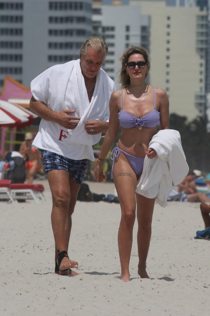 Dolph Lundgren and his young wife, Emma Krokdal, wearing a bikini, enjoying a day on the beach in Miami