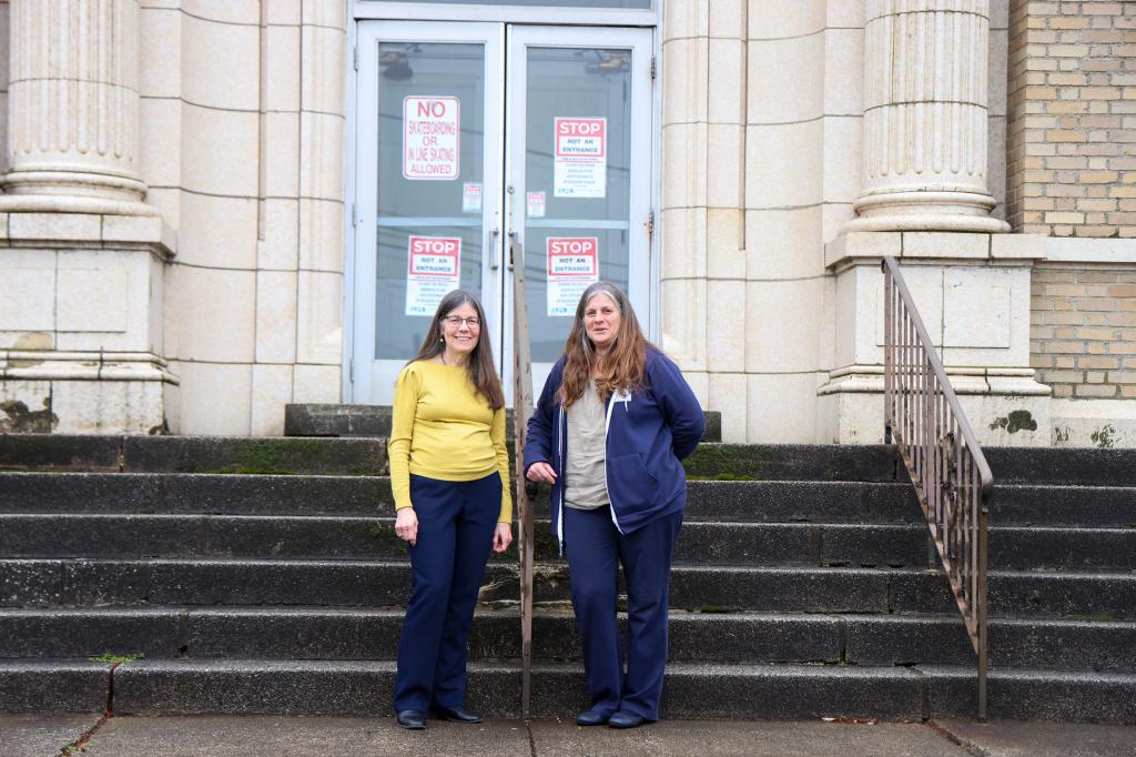 Kathleen Curran, Reference Librarian and Robyn Gilloon, Library Director of Lynbrook Library, on the front steps of the century-old building.