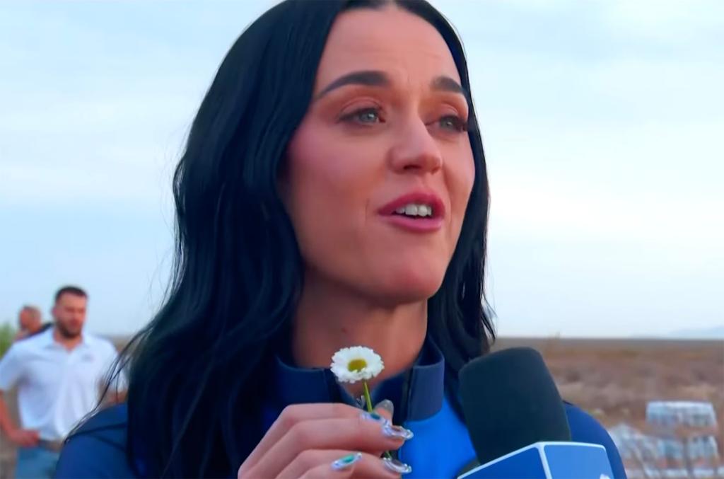 Katy Perry holding a daisy for her daughter, Daisy, after the Blue Origin flight. 