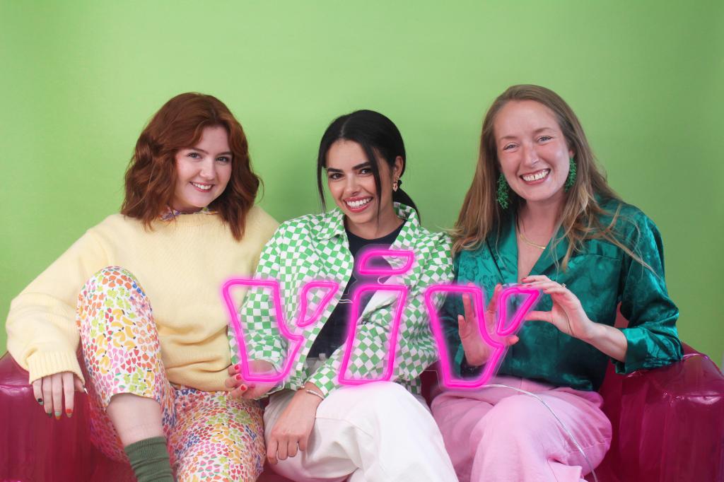 Founders of the Gen Z-founded period care brand Viv, Kelly, Katie and Anna, holding neon lights while promoting their BPA-free, organic cotton tampons