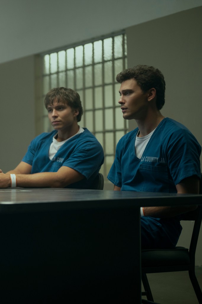 Nicholas Chavez as Lyle Menendez and Cooper Koch as Erik Menendez sitting at a table in episode 203 of Monsters: The Lyle And Erik Menendez Story