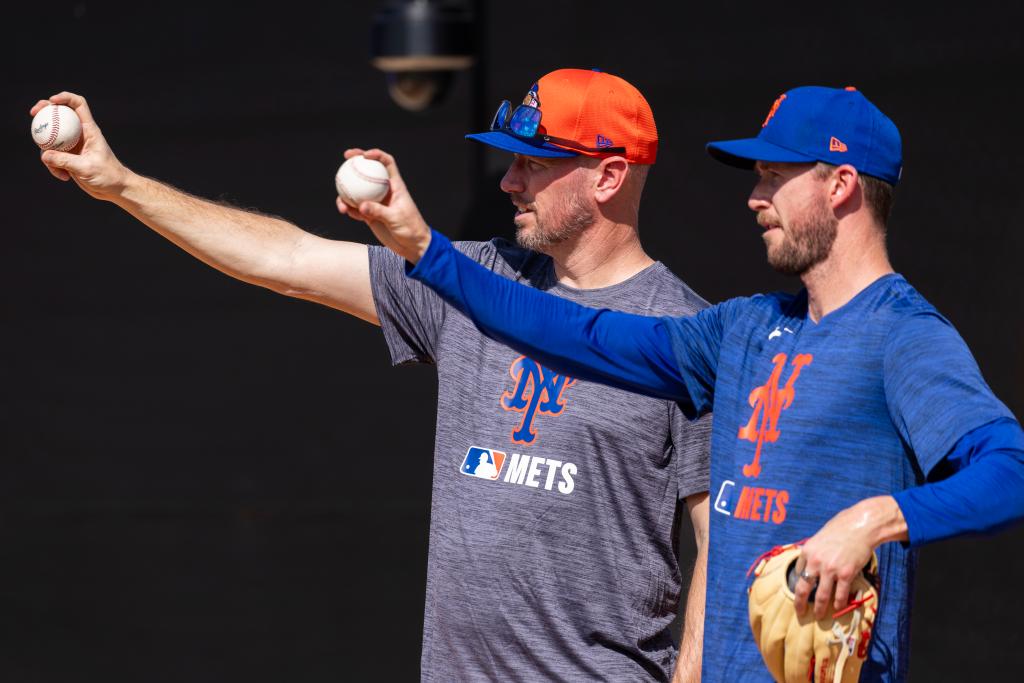 New York Mets pitching coach Jeremy Hefner guiding pitcher Griffin Canning during Spring Training session, pointing towards a baseball, in Port St. Lucie, FL on Feb. 10, 2025