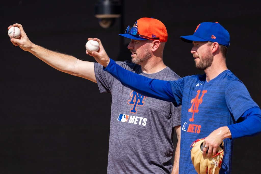 New York Mets pitching coach Jeremy Hefner guiding pitcher Griffin Canning during Spring Training session, pointing towards a baseball, in Port St. Lucie, FL on Feb. 10, 2025