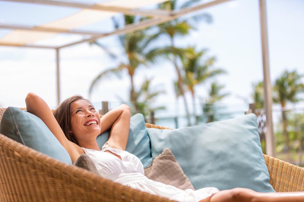 Luxury hotel home living woman relax enjoying sofa furniture of outdoor patio. 