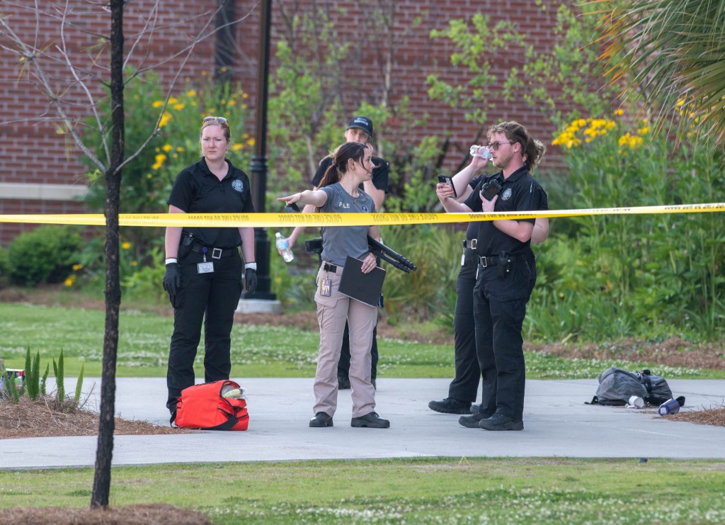 Law enforcement officers gather around at the scene of the fatal shooting on the campus of Florida State University in Tallahassee, Florida.