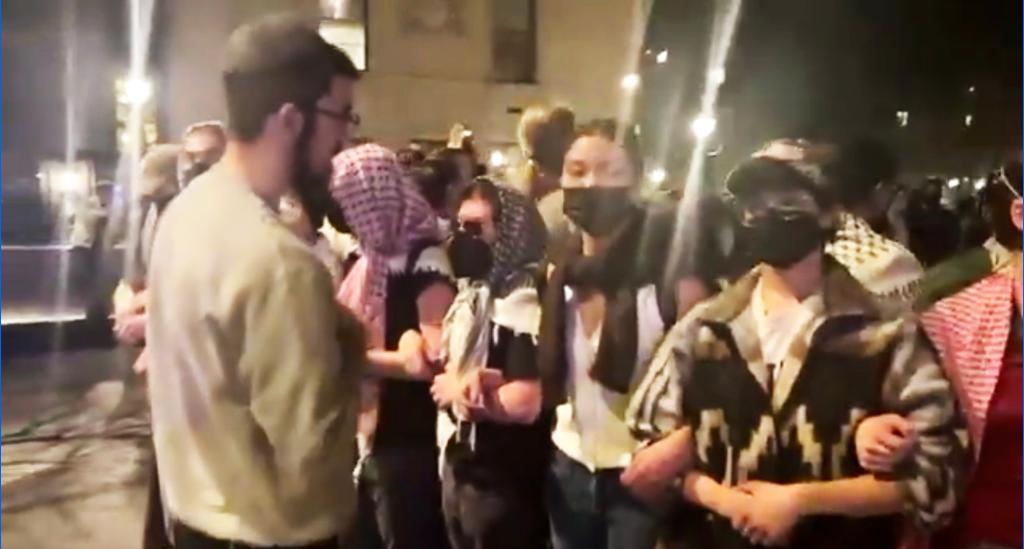 Netanel Crispe and protesters standing off