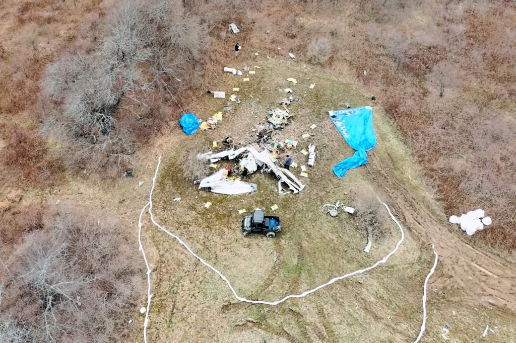 The remains of the Mitsubishi MU-2B-40 are scattered in pieces across a field in Copake, NY.