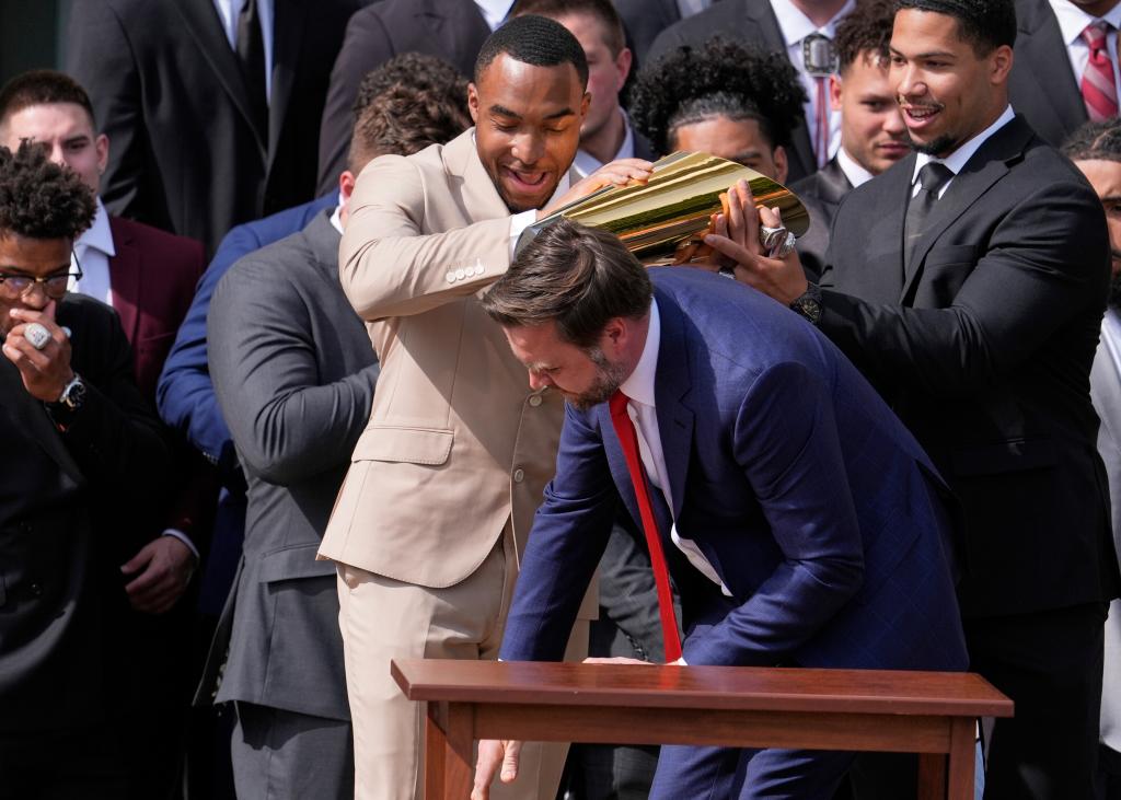 The bottom half of the championship trophy hits the ground.