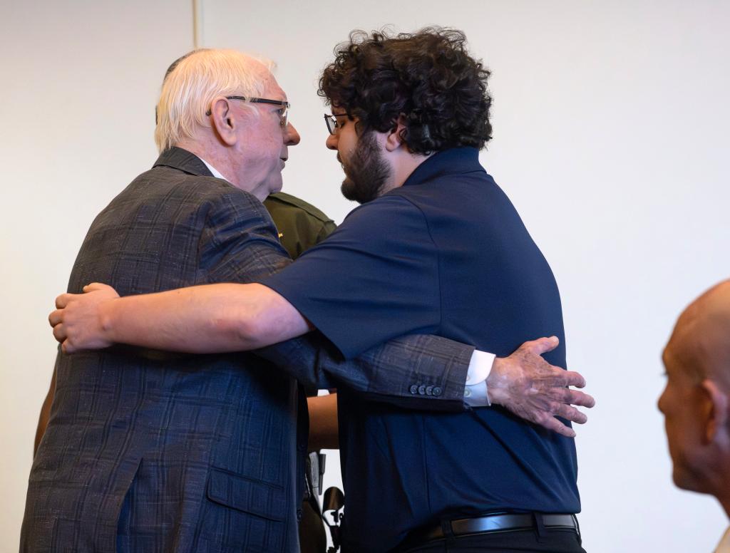 Orange County Superior Judge Jeffrey Ferguson embraces his son, Phillip Ferguson, before being led away in handcuffs on April 22, 2025, in Santa Ana, Calif. 