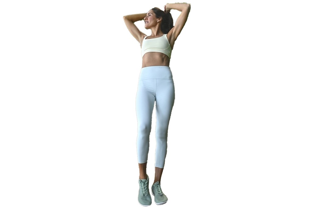 Woman wearing white sports garment and leggings