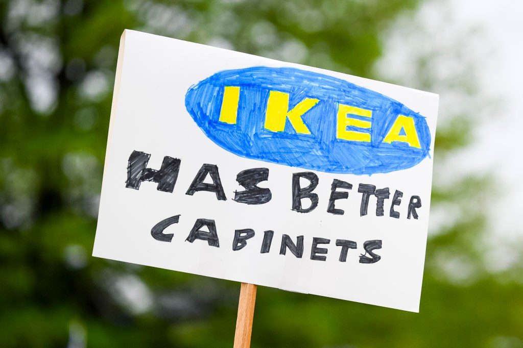 sign from protest against Trump that says "Ikea has better cabinets"