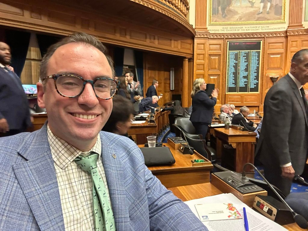 Rep Christopher Flanagan of Massachusetts poses on the legislative floor in a selfie posted to social media June 2024.