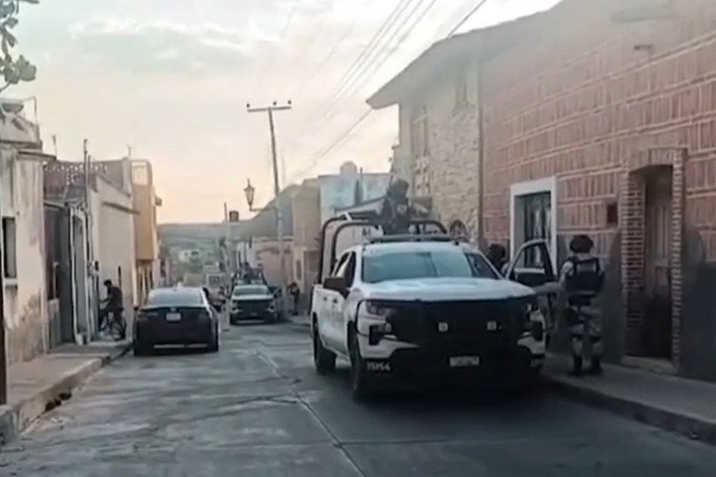 Armed police officers patrol the streets of Teocaltiche after the murder of Pereida.
