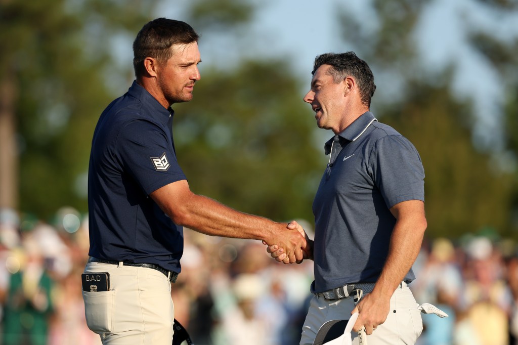 Bryson Dechambeau and Rory McIlroy shake hands on hole 18 of the Masters' final round.