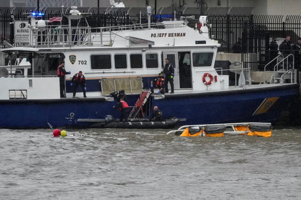 The helicopter is seen nearly fully submerged after the deadly crash.