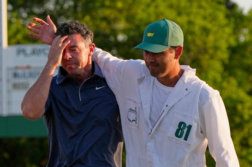 Rory McIlroy (l.) is embraced by caddie Harry Diamond (r.) after winning the Masters on April 13, 2025.