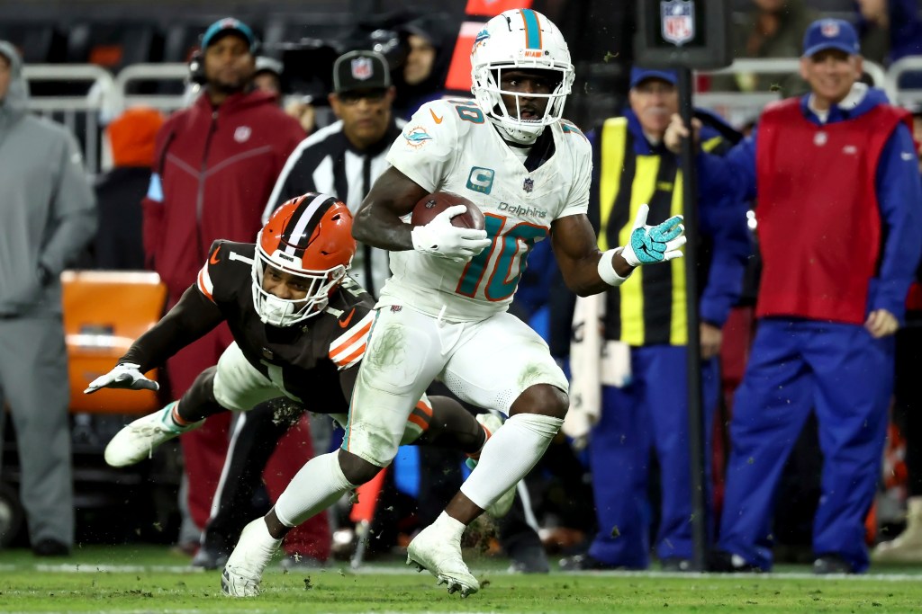 Miami Dolphins wide receiver Tyreek Hill (10) runs past Cleveland Browns safety Juan Thornhill (1) during an NFL football game, Sunday, December 29, 2024, in Cleveland.
